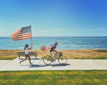 woman running holding an american flag